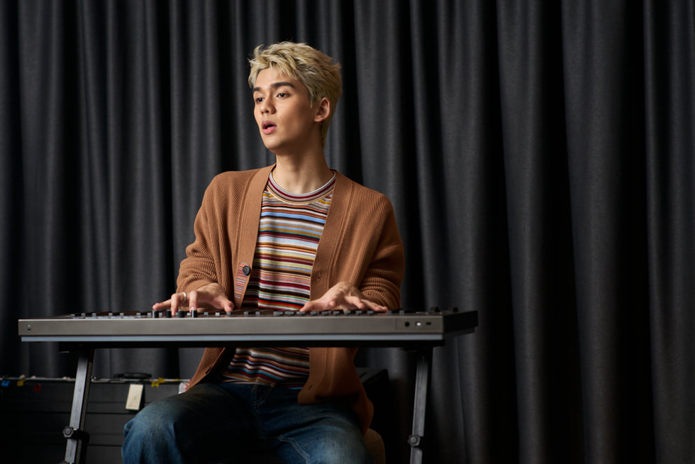 TIGGER plays the keyboard in a music studio.