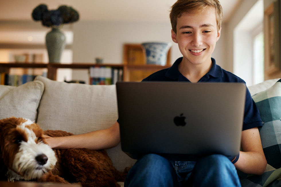 Young app developer Ben works on his MacBook Pro at home.